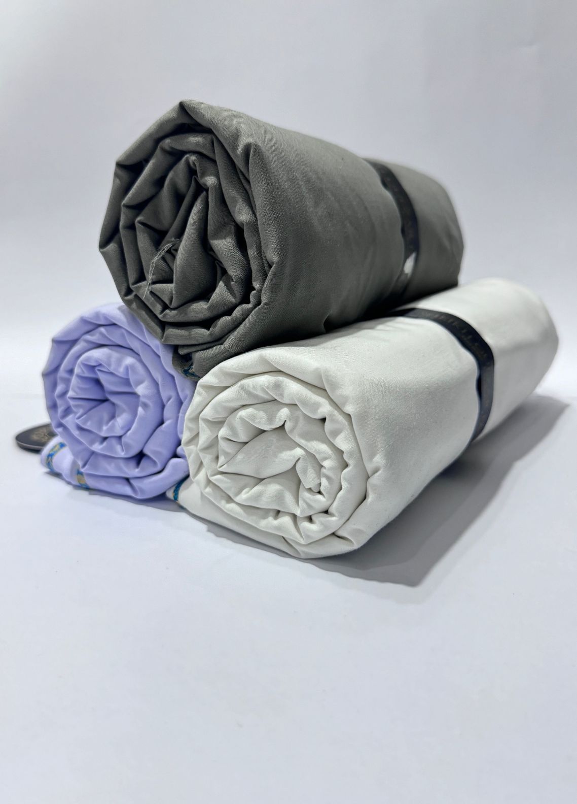 Rehmat 3-Suit Set bundle — premium unstitched men’s fabrics in grey, purple, and white, Ramadan special charity fabric offer Pakistan by SGF.