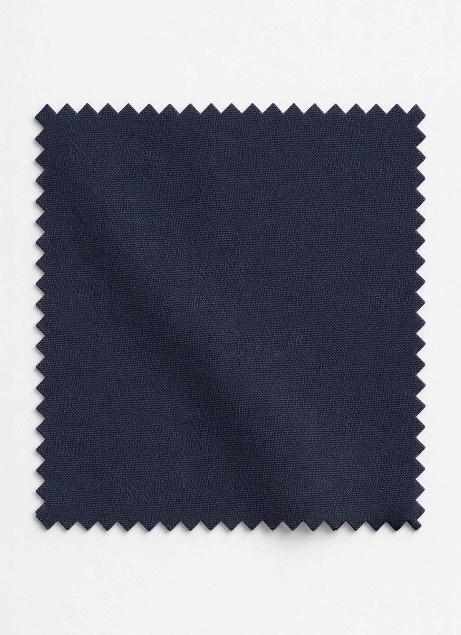 Close-up of charcoal grey unstitched shalwar kameez fabric showing its smoky tone