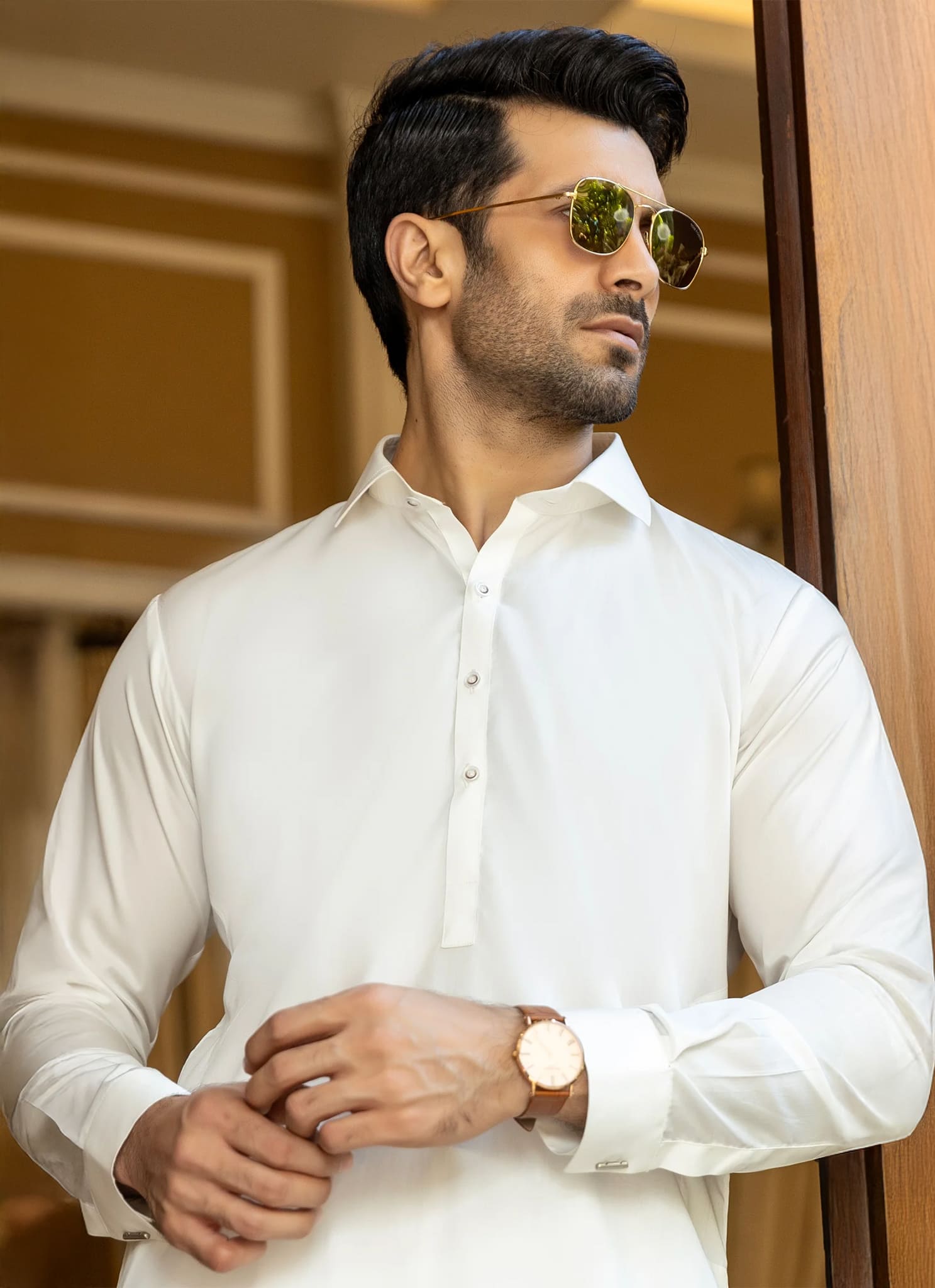 Man wearing a white shirt and sunglasses indoors
Viven by SGF — lifestyle image of premium white wash n wear fabric outfit, wrinkle-free self-check men’s fabric Pakistan.