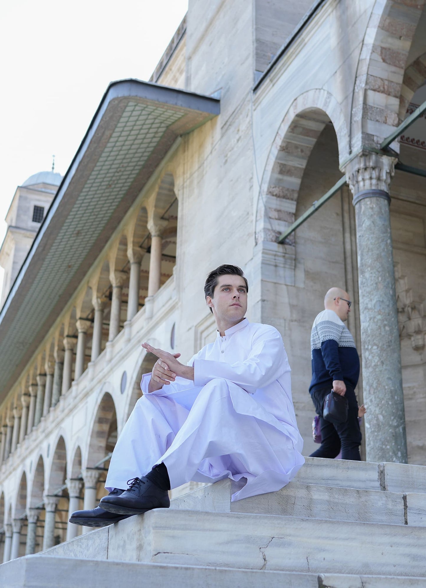 White Sultan fabric by SGF — premium men’s white shalwar kameez fabric styled outdoors, breathable, timeless unstitched luxury fabric Pakistan.